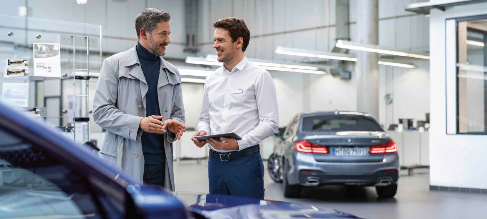 A man sensitively touching his BMW. A man sensitively touching his BMW.